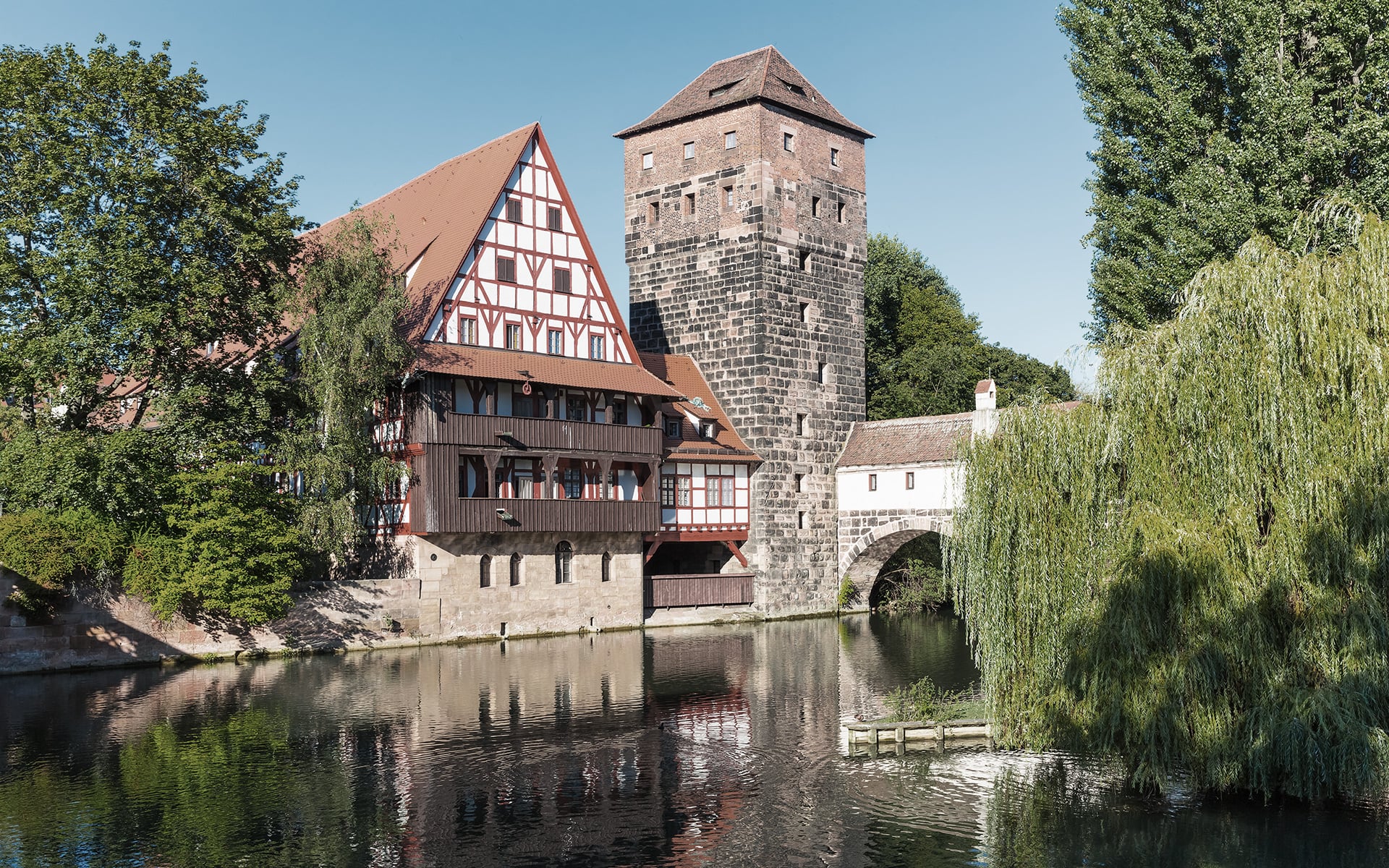 The medieval building Weinstadel and the historic water tower next to the river Pegnitz in Nuremberg, Germany