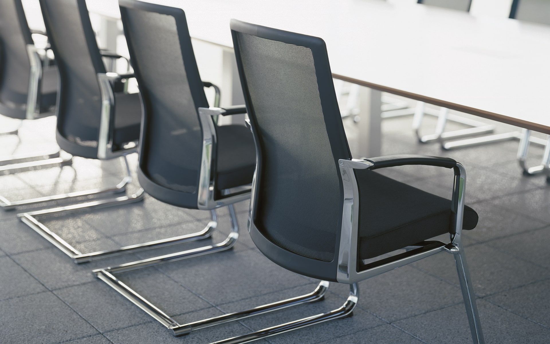 Close-up of black K+N Agenda conference chairs by ITO Design with mesh backrests