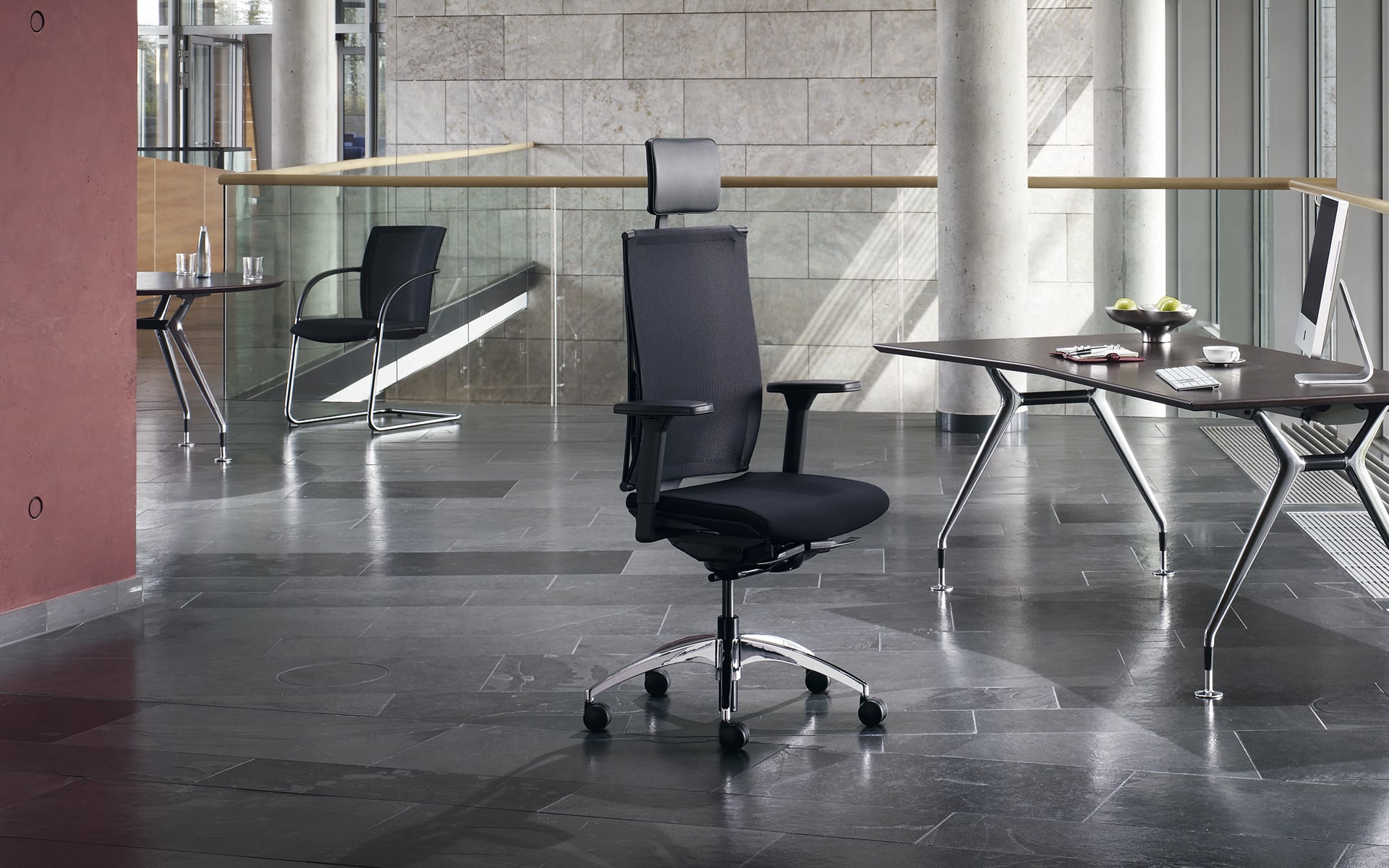 Black K+N Okay office chair by ITO Design in elegant office with dark marble tiles