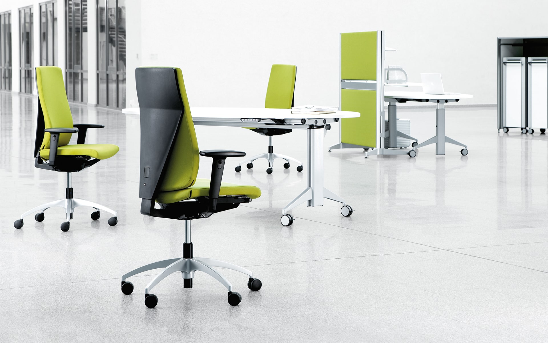 Three K+N Signeta office chairs by ITO Design with bright green upholstery in monochromatic office