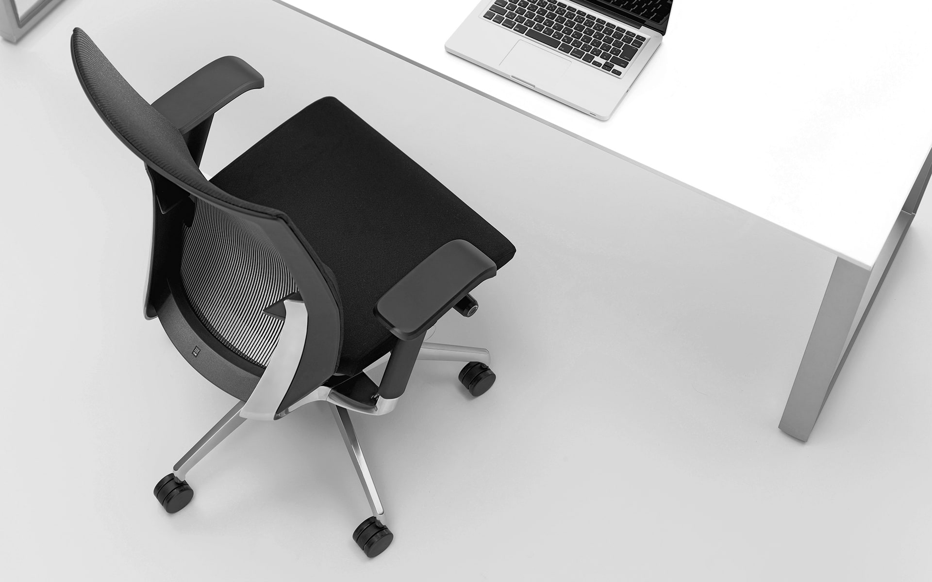 High-angle shot of the ITOKI Vento office chair by ITO Design in black at minimalist desk