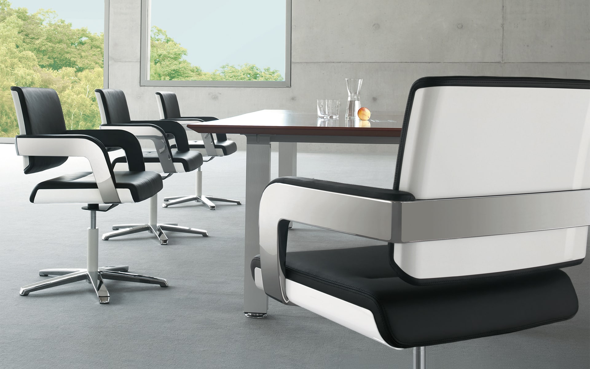 Black-and-white K+N Charta conference chairs by ITO Design in conference hall with large windows