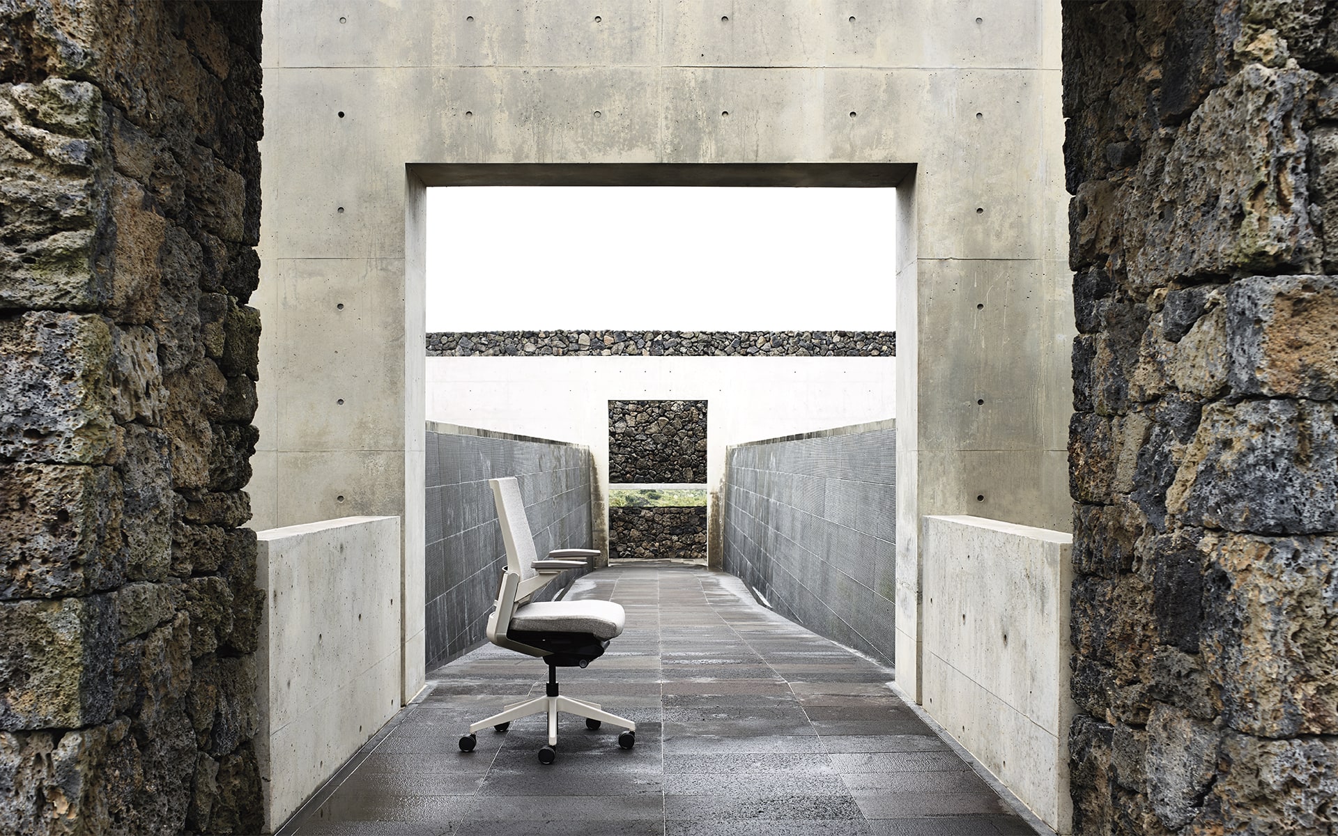 Gray Sidiz T80 executive office chair by ITO Design in outdoor area with raw stones