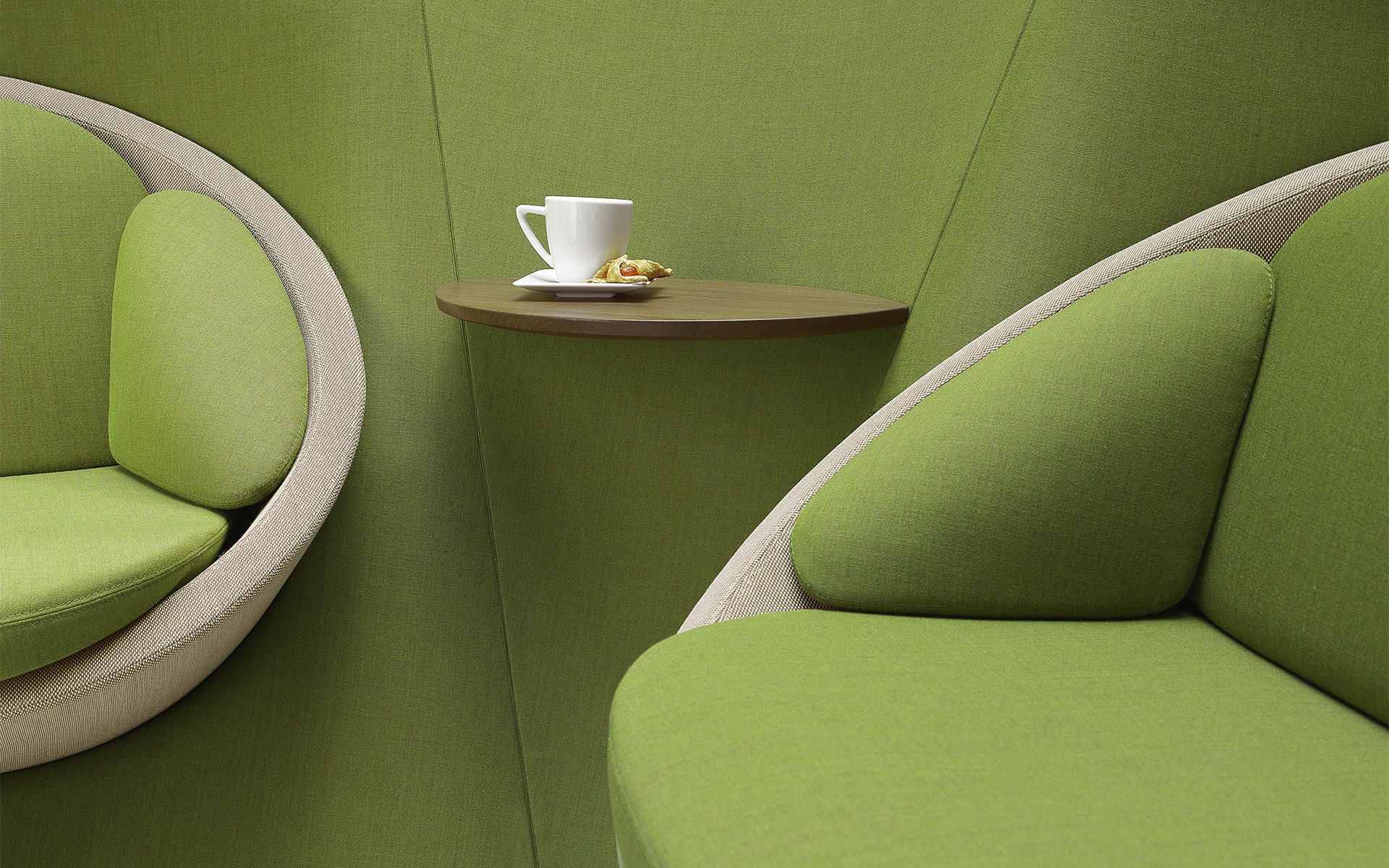 Close-up of the Profim Wyspa lounge seating system by ITO Design in green with integrated shelf