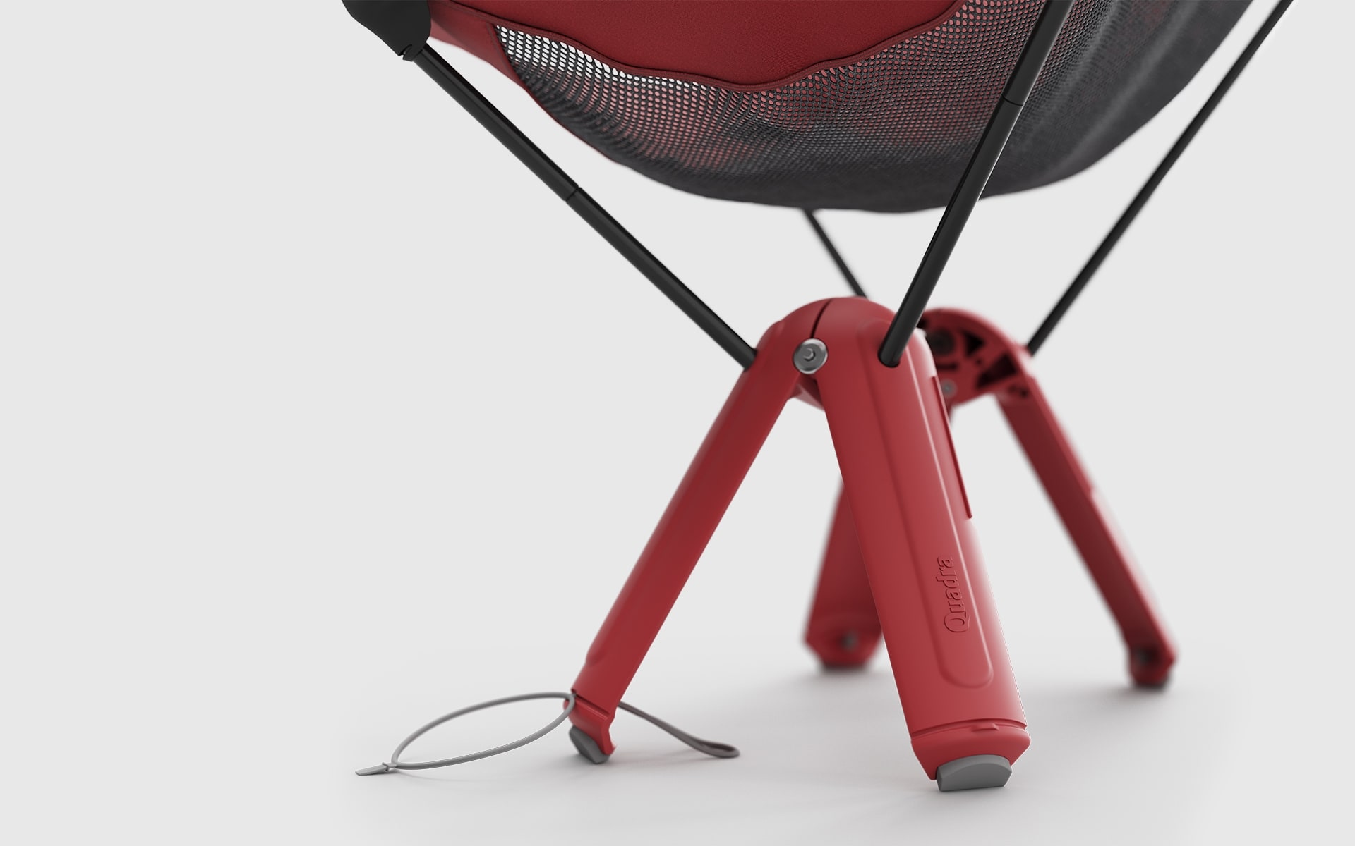 Close-up of the chair legs of a red Therm-a-Rest Quadra camp chair by ITO Design – the legs function as easy-stow package at the same time