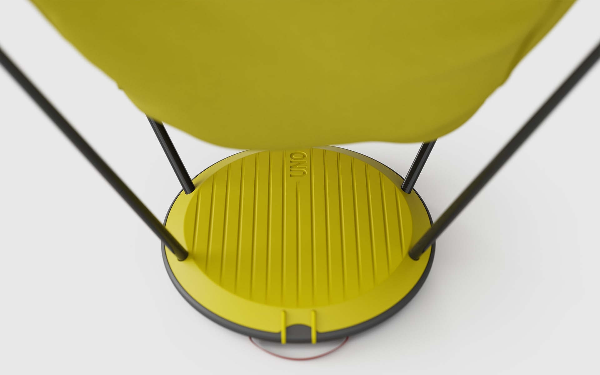 Close-up of the disc shaped base of a yellow Therm-a-Rest Uno outdoor chair by ITO Design