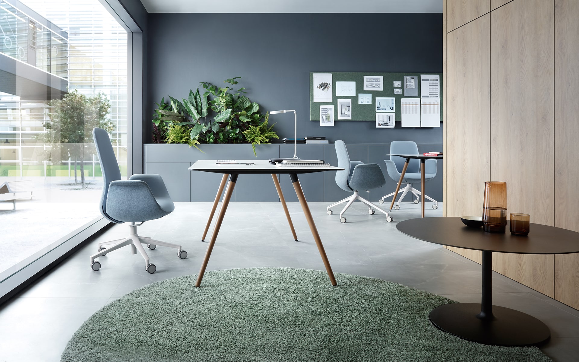 Three blue grey Profim Ellie chairs by ITO Design in light-flooded modern office