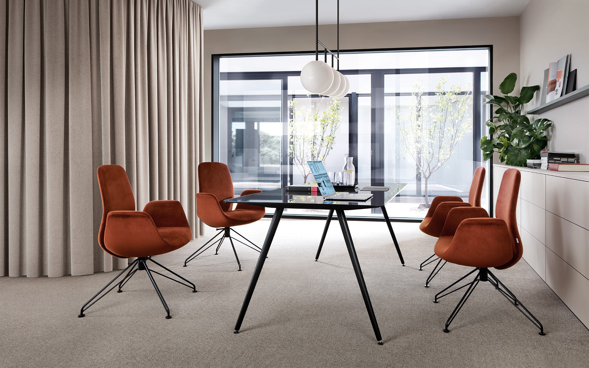 Four rust-red Profim Ellie chairs with black metal legs by ITO Design in modern conference room