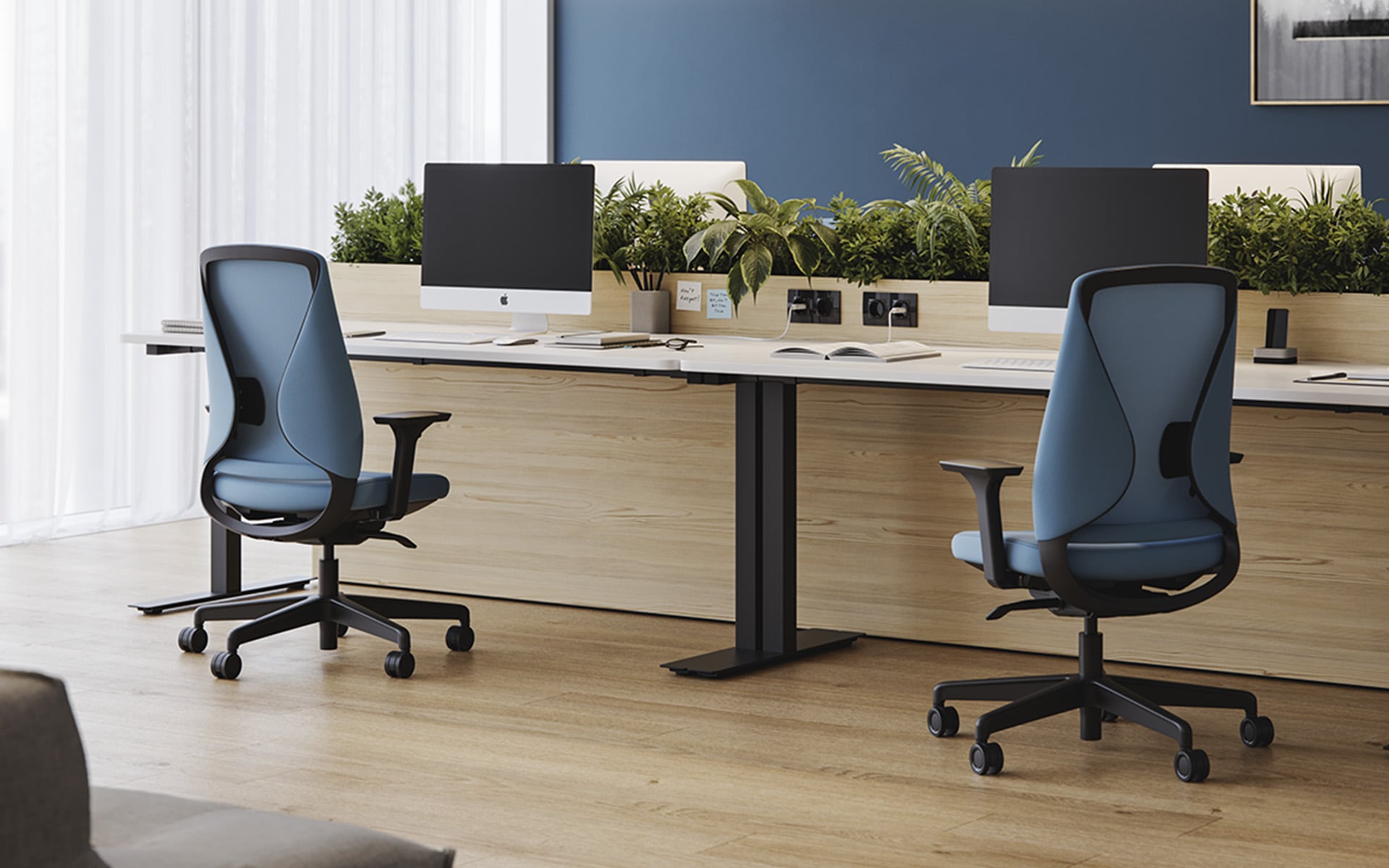 Two Comfordy Silhouette Office chairs by ITO Design with light blue upholstery in modern office with many plants