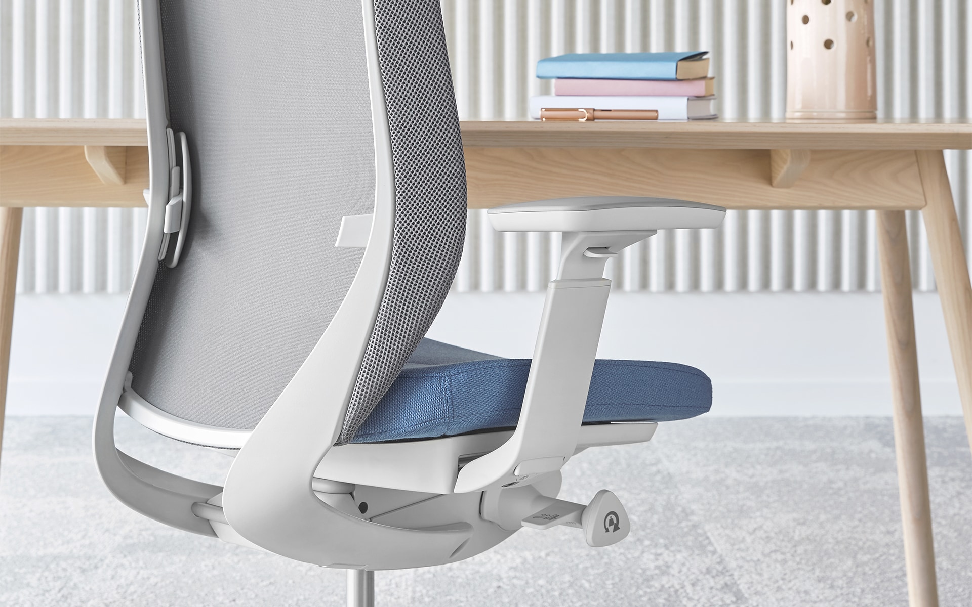 The Profim Accis Pro office chair by ITO Design in white with light blue upholstery at minimalist desk