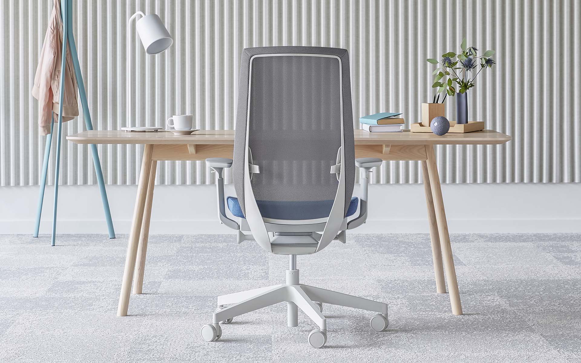 Light grey Profim Accis Pro office chair by ITO Design with light blue upholstery at minimalist desk