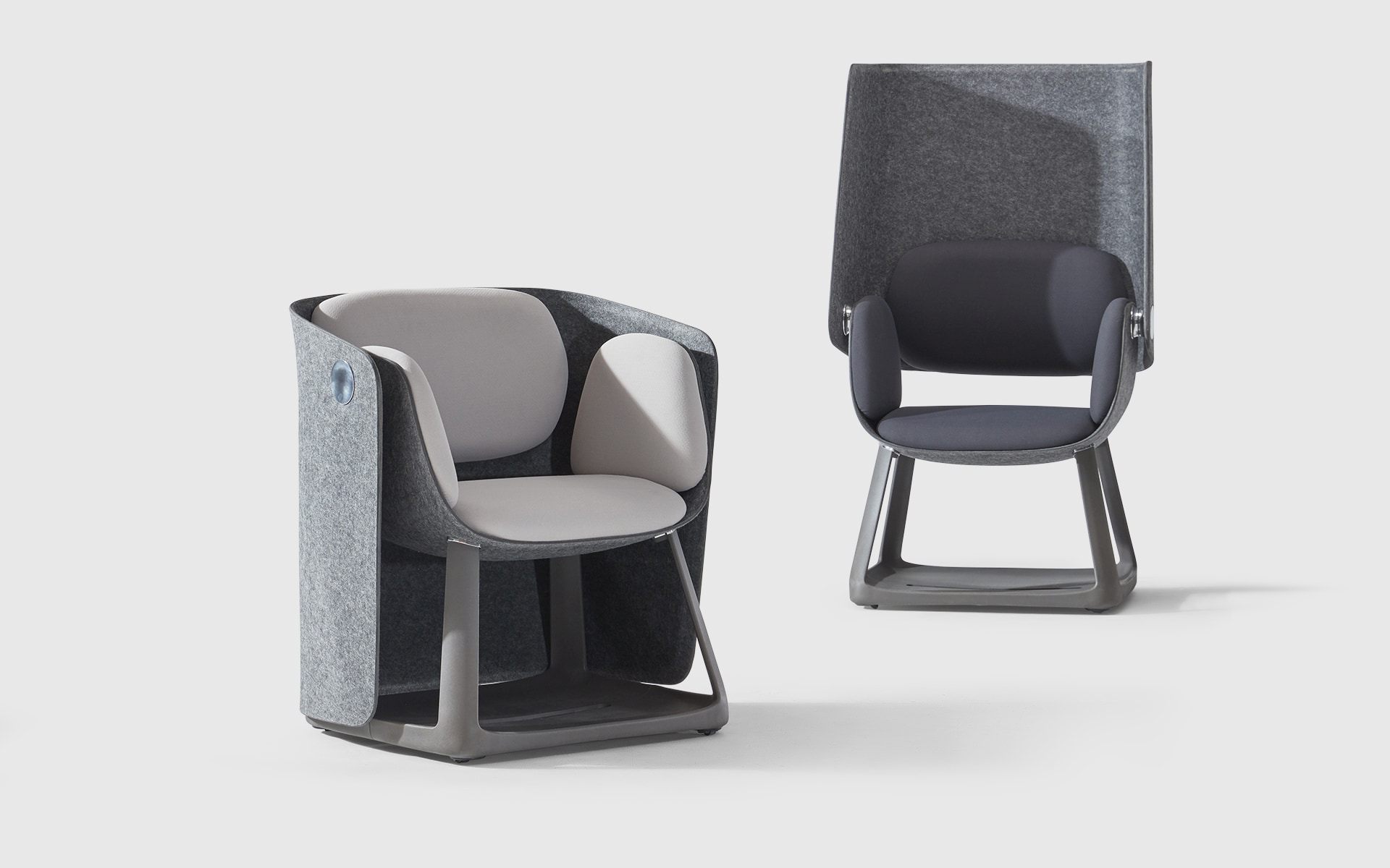 Two Sunon UF office chairs by ITO Design with their folding screen folded up and down