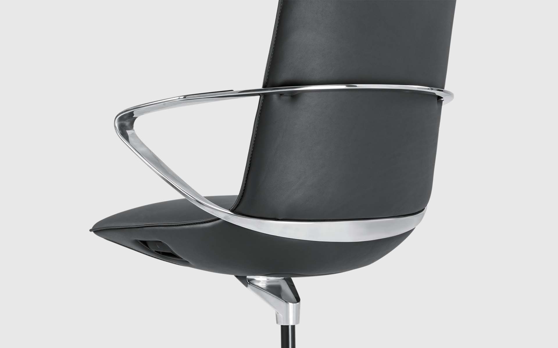 Close-up of the back side and elegantly curved armrest of a black Goodtone Amola leather chair by ITO Design