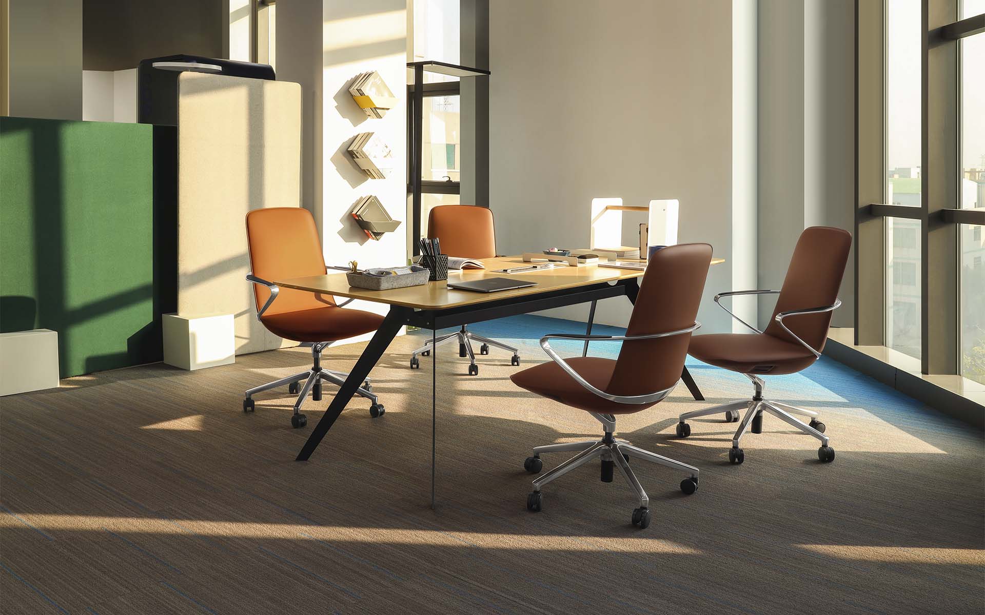 Light-flooded conference room with four brown Goodtone Amola executive chairs by ITO Design