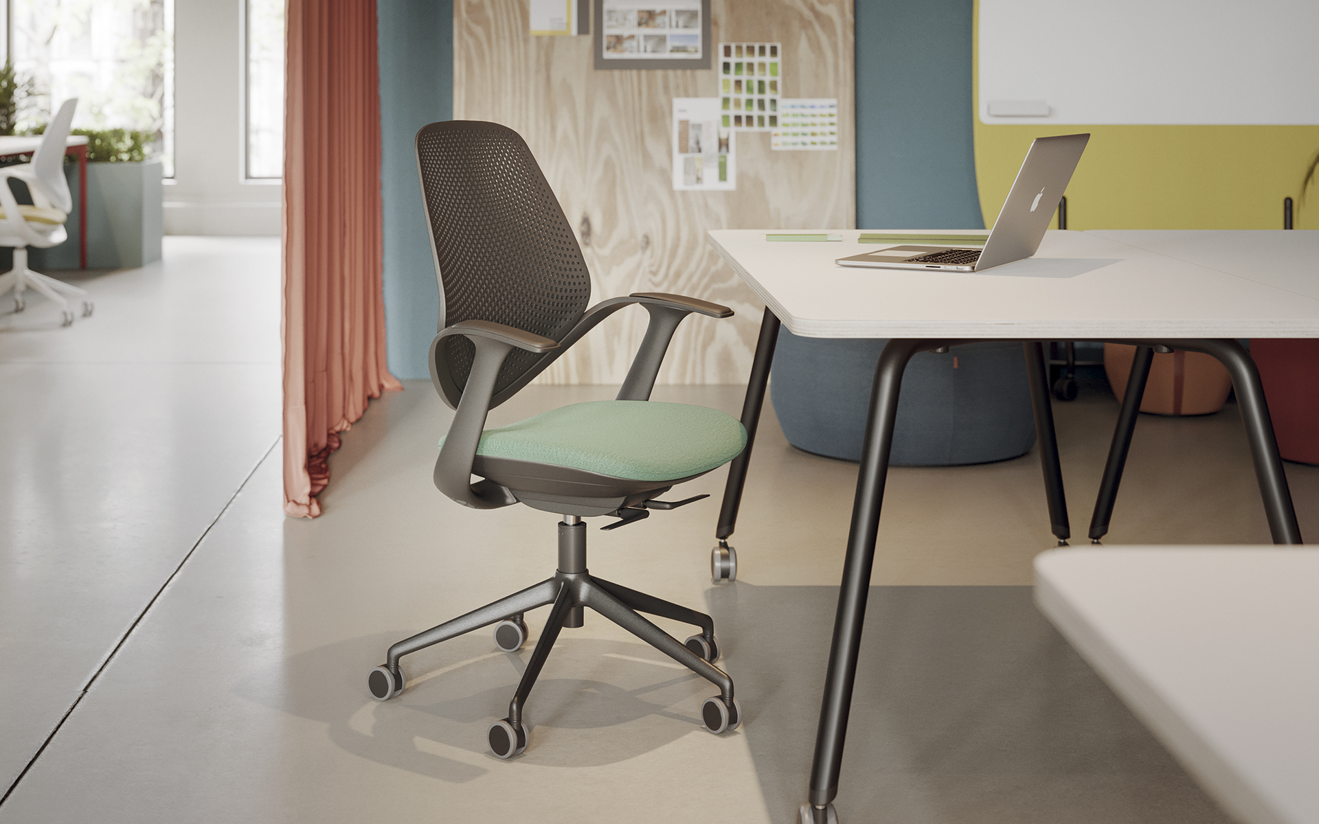 Forma 5 Flow office chair by ITO Design with padded seating surface in mint, back and armrests in dark grey in front of a desk in a bright, open office.