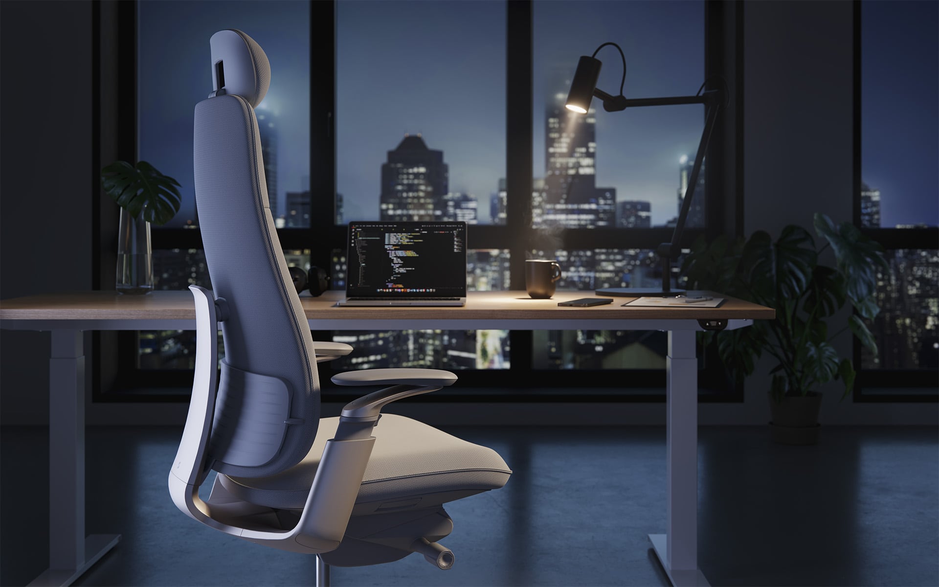 Night-time office scene featuring the Sidiz T90 office chair by ITO Design for Sidiz in light grey, placed at a modern desk with a glowing laptop and a stunning view of a city skyline at night.